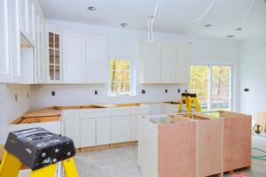 Custom-kitchen-cabinets-in-various-stages-of-installation-base-for-island-in-center-Installation-of-kitchen-cabinets-300x200